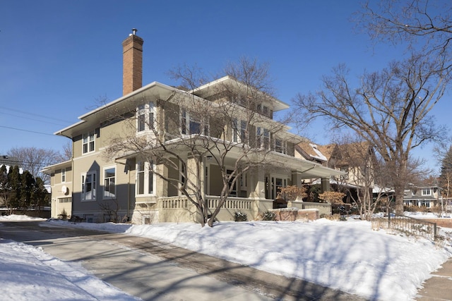 exterior space featuring a chimney and a porch