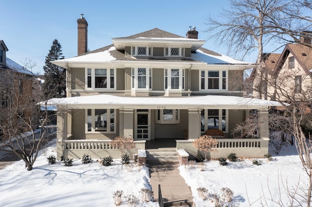 traditional style home with a chimney and a porch