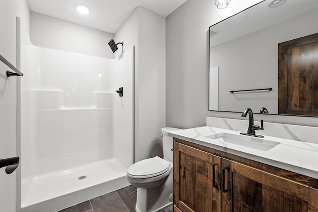 bathroom featuring vanity, a shower, and toilet