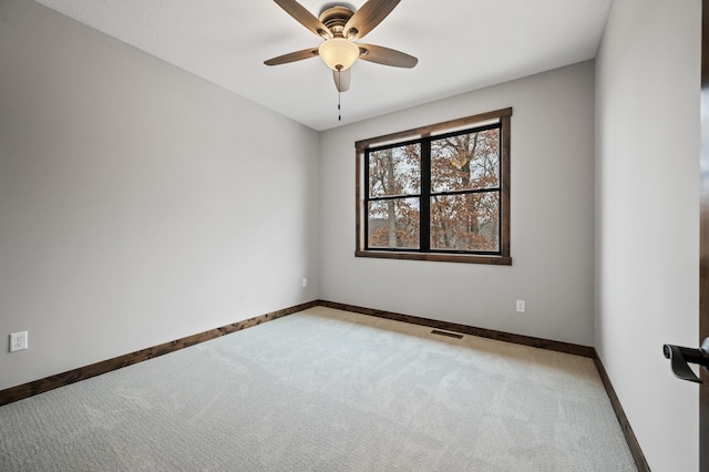 empty room featuring carpet floors and ceiling fan