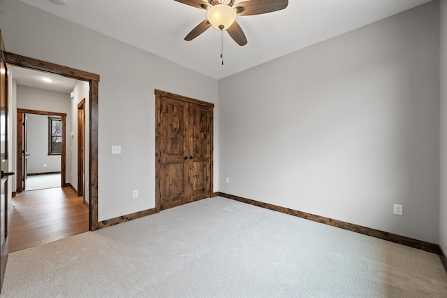 unfurnished bedroom featuring ceiling fan and carpet