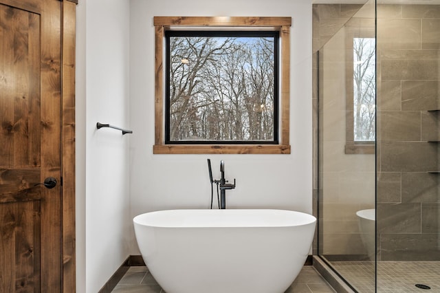 bathroom featuring tile patterned flooring and shower with separate bathtub