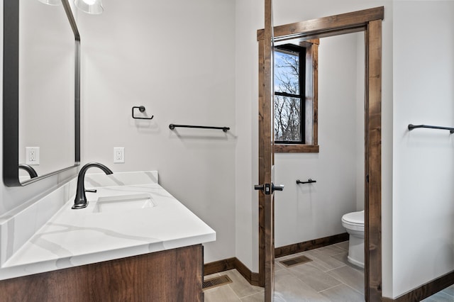 bathroom with vanity, tile patterned floors, and toilet