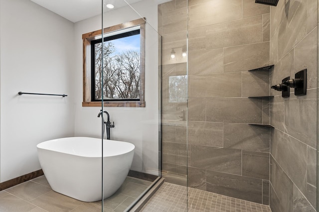 bathroom with tile patterned floors and shower with separate bathtub