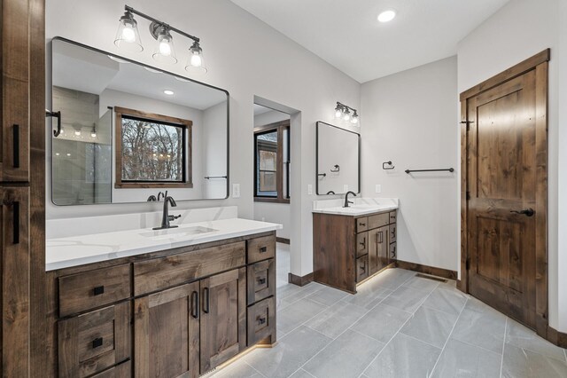 bathroom with tile patterned flooring, vanity, and a shower with shower door