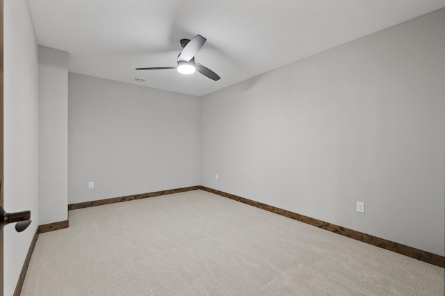 unfurnished room featuring light carpet and ceiling fan