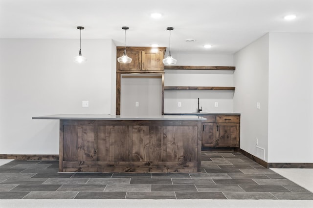 bar featuring decorative light fixtures and sink