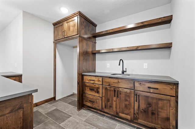 kitchen featuring sink and a textured ceiling