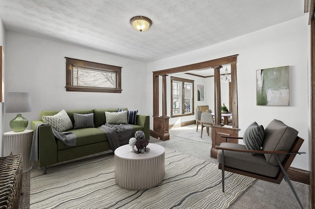 818 Sherburne Ave, Saint Paul, MN 55104 - carpeted living area with ornate columns and a textured ceiling