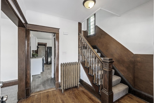 818 Sherburne Ave, Saint Paul, MN 55104 - stairway with radiator, hardwood / wood-style flooring, and ornamental molding