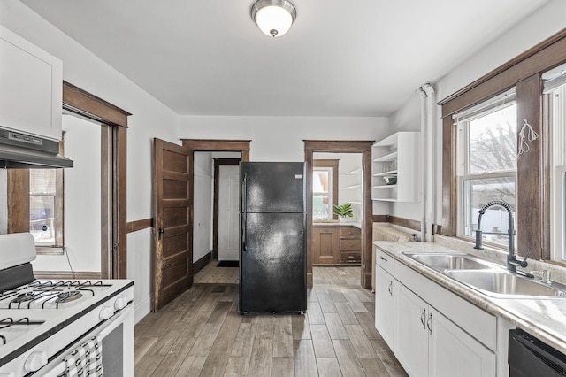 818 Sherburne Ave, Saint Paul, MN 55104 - kitchen with black appliances, a sink, light wood finished floors, and white cabinetry
