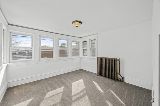 818 Sherburne Ave, Saint Paul, MN 55104 - empty room featuring radiator heating unit, carpet flooring, and baseboards