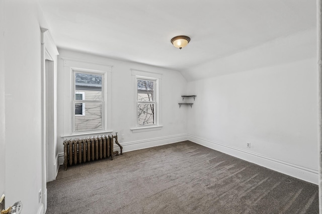 818 Sherburne Ave, Saint Paul, MN 55104 - spare room featuring radiator, dark colored carpet, lofted ceiling, and baseboards