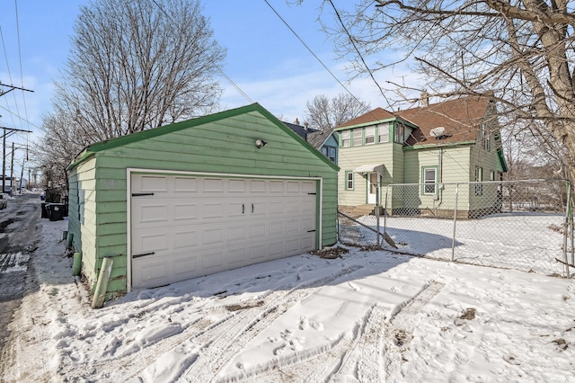 818 Sherburne Ave, Saint Paul, MN 55104 - snow covered garage featuring fence and a detached garage