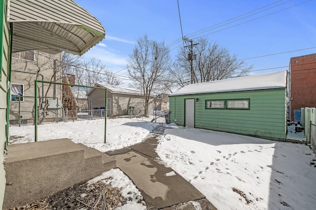818 Sherburne Ave, Saint Paul, MN 55104 - yard layered in snow featuring fence and an outbuilding