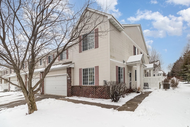 view of snow covered exterior with a garage