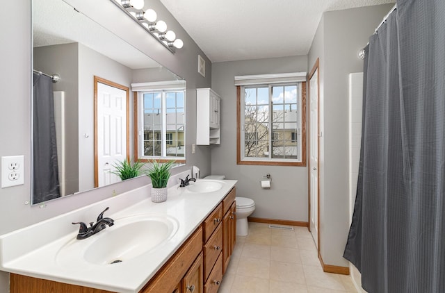 bathroom with vanity, walk in shower, a textured ceiling, and toilet