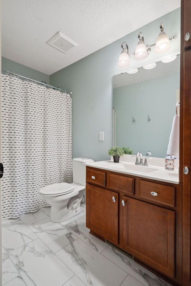 bathroom with toilet, marble finish floor, curtained shower, a textured ceiling, and vanity