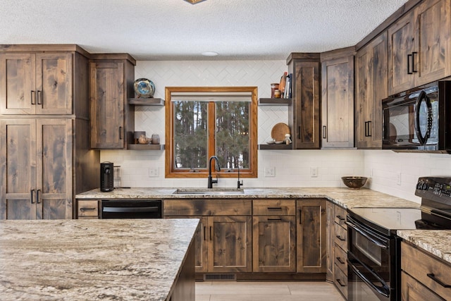 kitchen with tasteful backsplash, open shelves, light stone counters, black appliances, and a sink