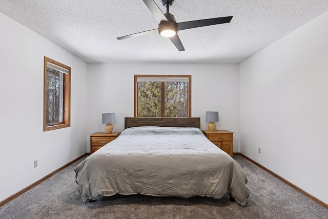 bedroom featuring ceiling fan, baseboards, carpet floors, and a textured ceiling