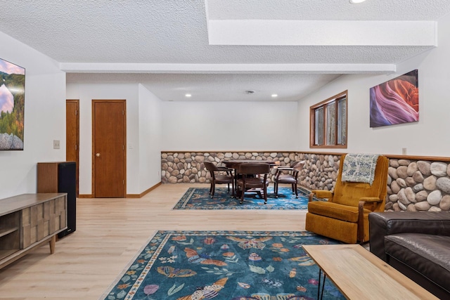 living room featuring wood finished floors and a textured ceiling