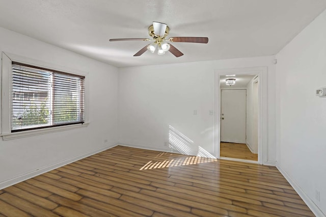 empty room featuring dark hardwood / wood-style floors and ceiling fan