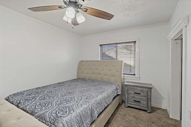 carpeted bedroom with crown molding, ceiling fan, and a textured ceiling