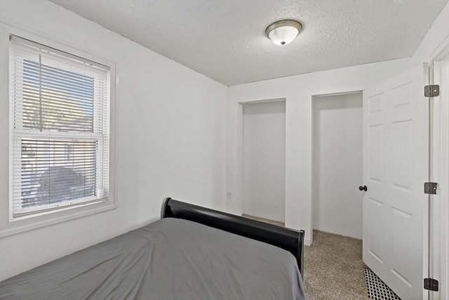 unfurnished bedroom with carpet flooring and a textured ceiling