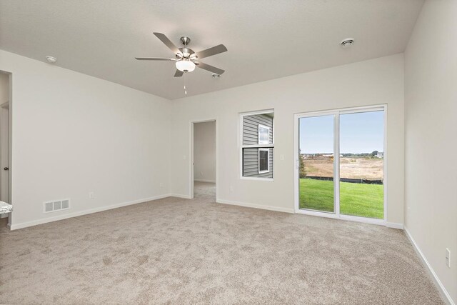 interior space featuring ceiling fan, light carpet, and access to outside