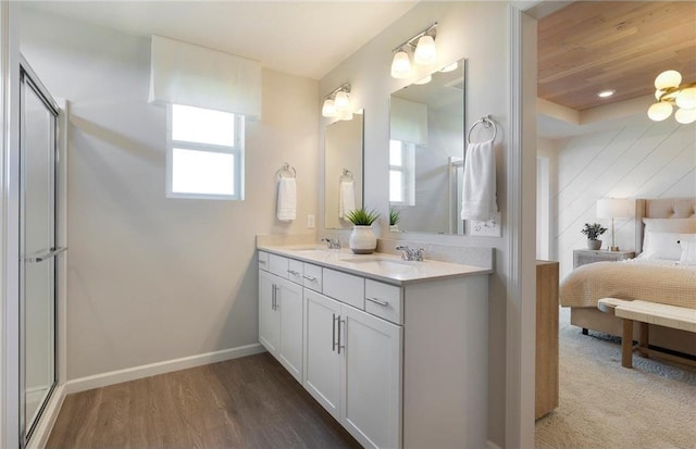 bathroom with vanity, a shower with door, and hardwood / wood-style floors