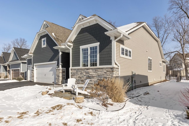 view of front of home featuring a garage and stone siding