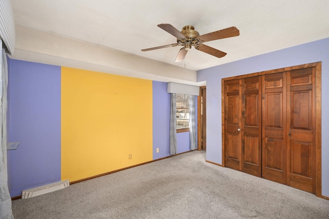 unfurnished bedroom featuring ceiling fan, carpet floors, visible vents, and baseboards