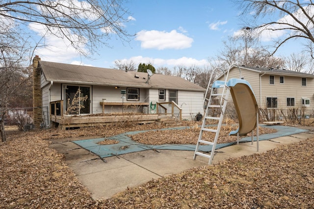 rear view of property featuring fence and a chimney