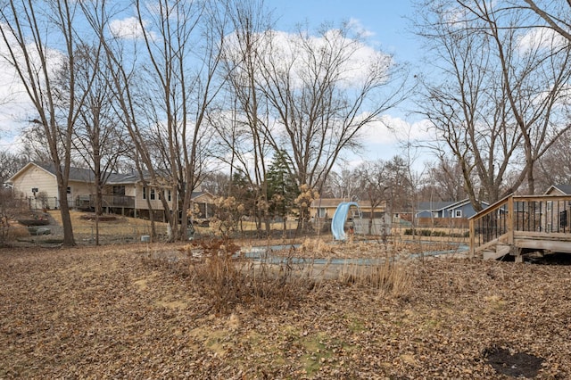 view of yard with fence and a deck