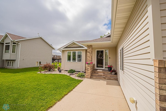 doorway to property with a yard