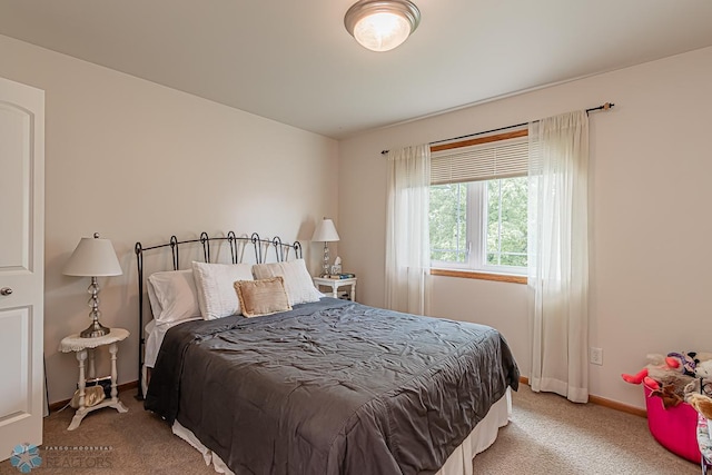 bedroom with carpet and baseboards