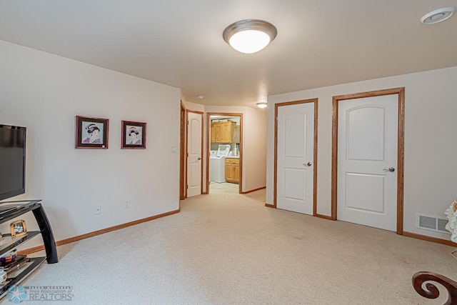 interior space featuring baseboards, visible vents, and light colored carpet