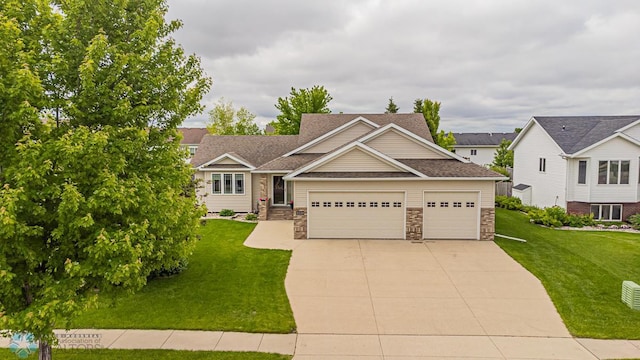 view of front of home featuring a garage, a front yard, concrete driveway, and stone siding