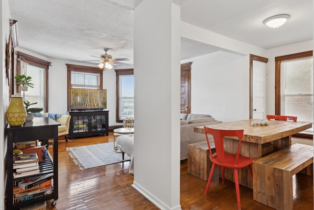 dining room featuring ceiling fan, hardwood / wood-style floors, and a textured ceiling