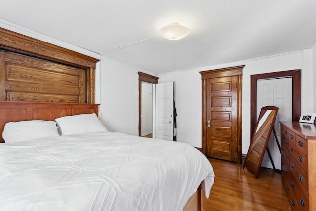 bedroom with hardwood / wood-style flooring