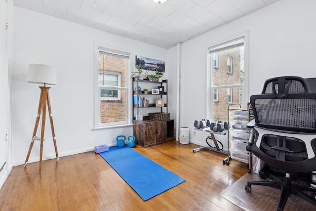 workout area with wood-type flooring