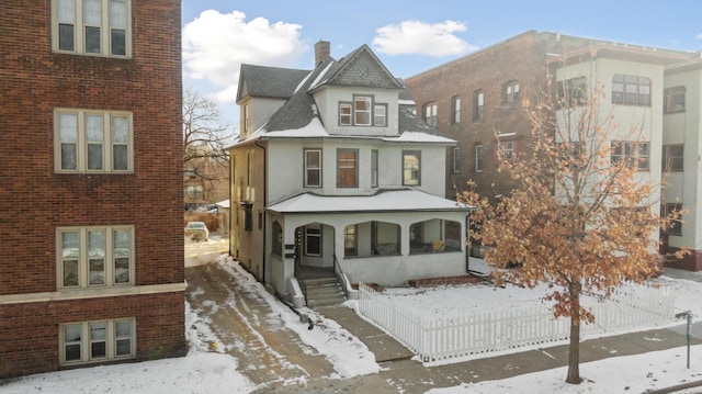 view of front of property featuring brick siding and fence