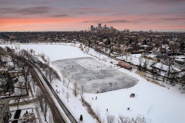 snowy aerial view featuring a view of city