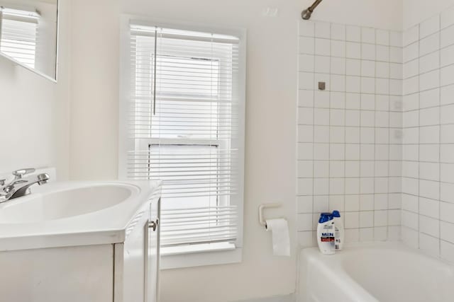 full bathroom featuring shower / tub combination, vanity, and a healthy amount of sunlight