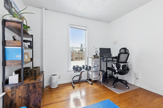 office featuring baseboards and hardwood / wood-style floors