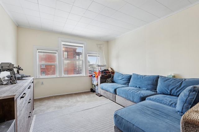living area with light colored carpet and baseboards