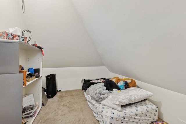 bedroom with carpet flooring and vaulted ceiling