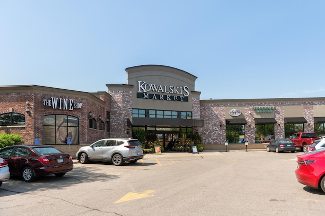 view of building exterior with uncovered parking