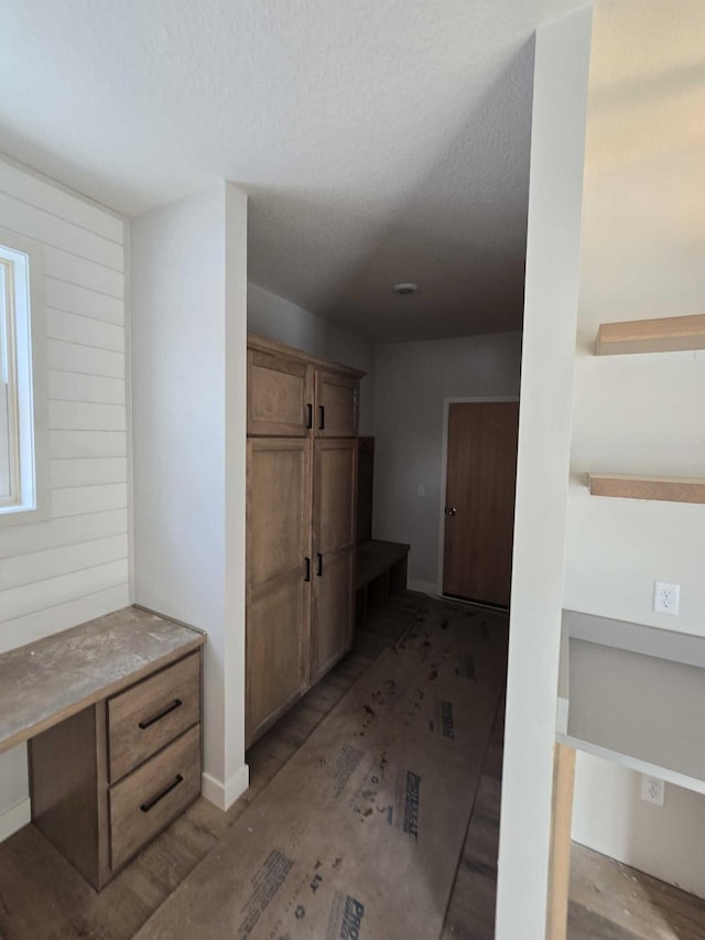 bathroom with wood-type flooring and a textured ceiling