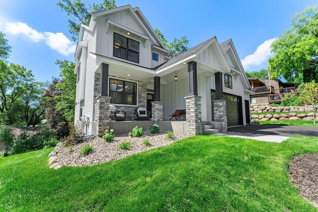 932 Orchard Ln, Roseville, MN 55113 - view of front facade with a porch, board and batten siding, stone siding, and a front yard